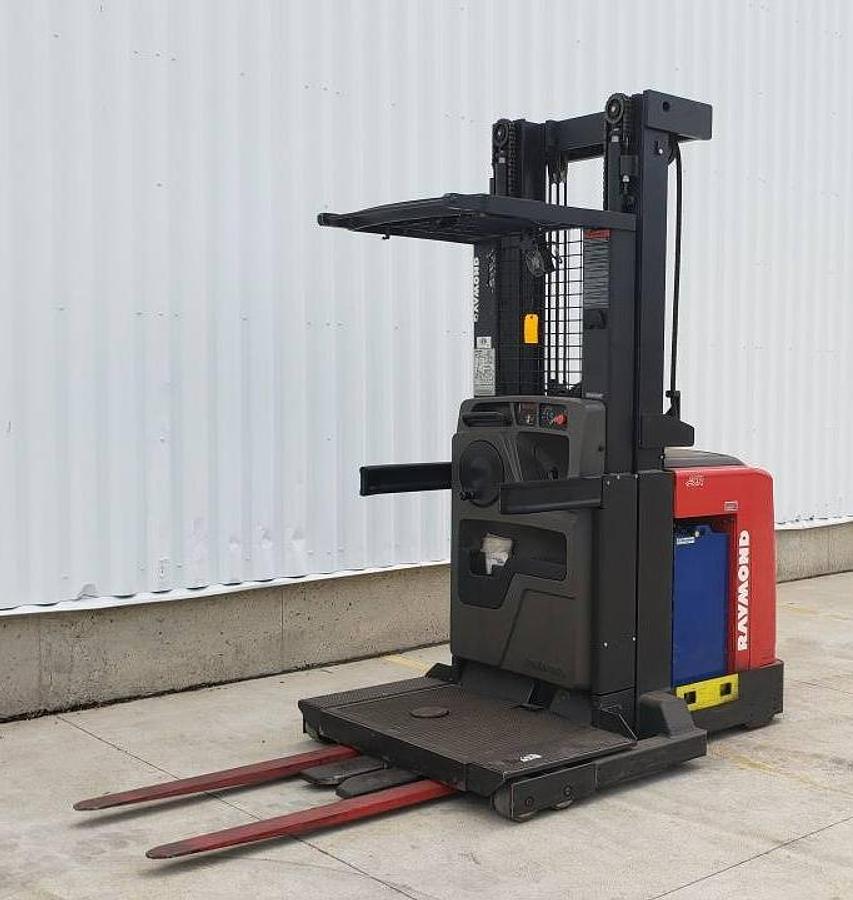 Opposite front angle view of refurbished 2013 Raymond 550-OPC30TT electric order picker showing mast, carriage, operator platform, and chassis during Mississauga deployment