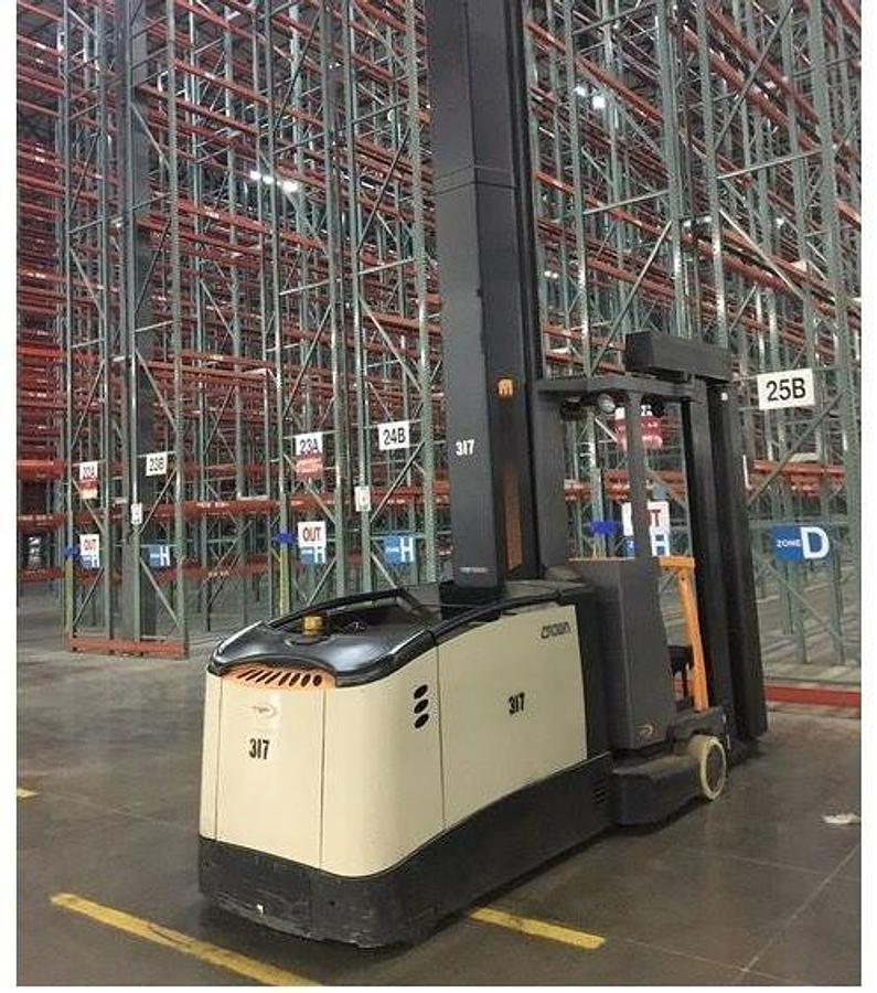 Rear side view of refurbished 2017 Crown TSP7000 electric turret truck showing rear chassis, 72 volt battery compartment, and CSA certification decal during Ontario deployment.