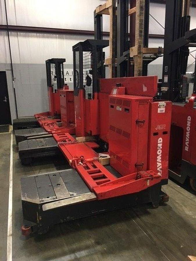 Side profile of 2012 Raymond 9300-SL60TN electric sideloader showing 48" bed, mast rails, and bi-directional chassis during Brampton deployment