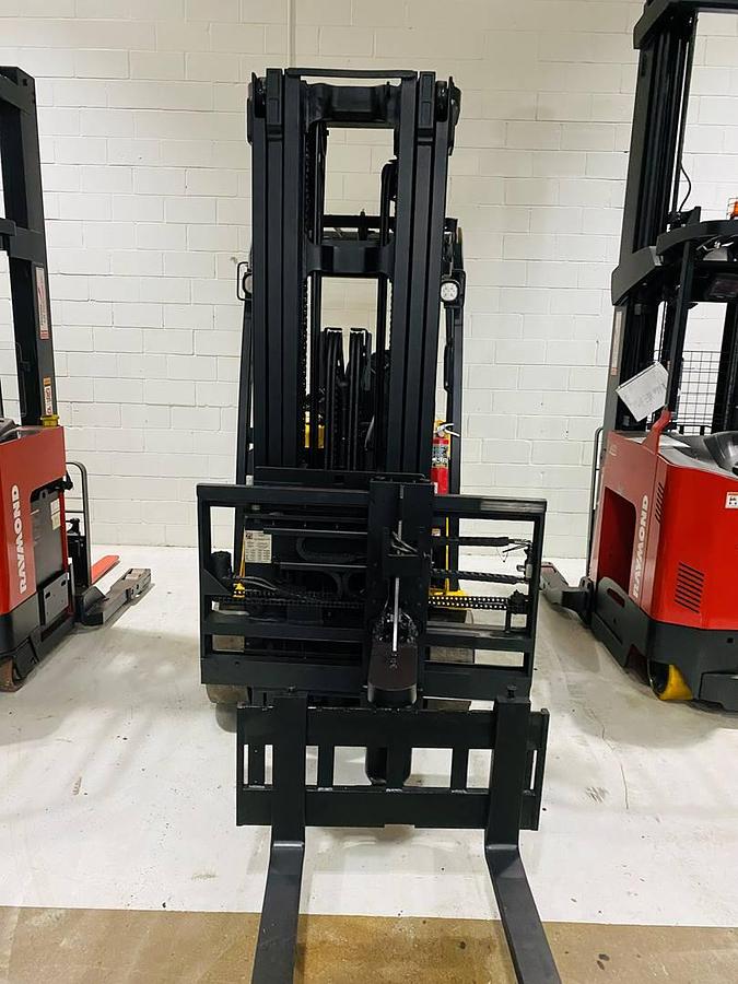 Front view of refurbished 2014 Yale ERC080VHN48TE100 electric cushion tire forklift showing fork carriage, mast extension, and swing mast articulation during Ontario deployment