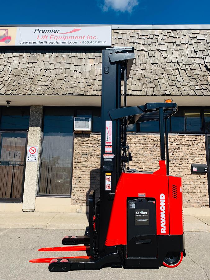 Side view of CSA-certified Raymond 750-R45TT reach truck with triple mast and poly tires – staged in Brampton ON