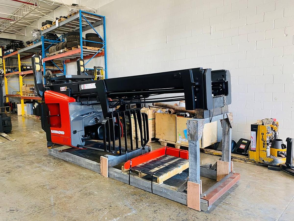 Laid down and cradled Front angled view showing mast rails and 42” fork tips