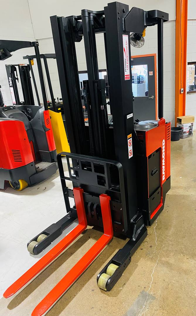 • Front View: Raymond EASIR40TT reach truck with 42″ forks and poly tires.