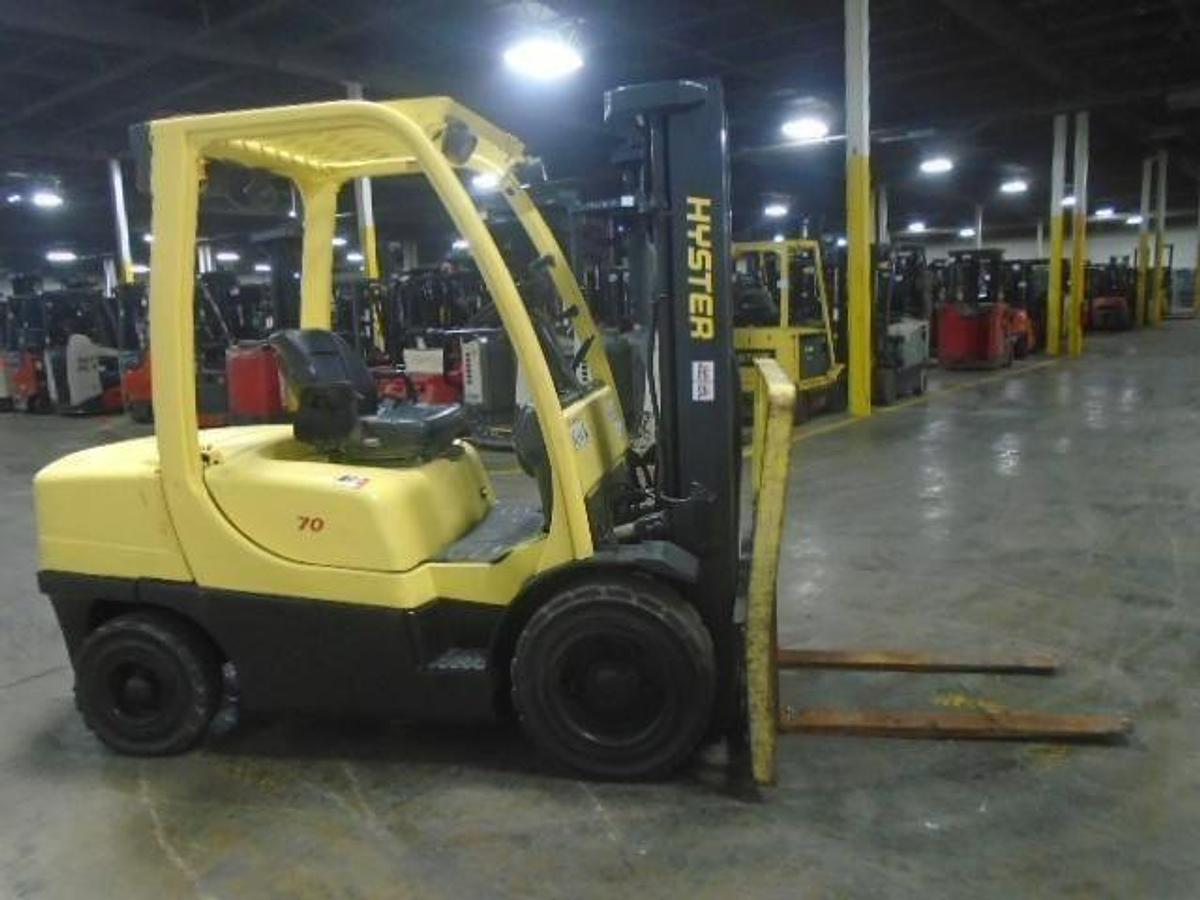 Side profile of Hyster H70FT diesel forklift showing 3-stage mast, side shifter, and pneumatic tires during Brampton deployment