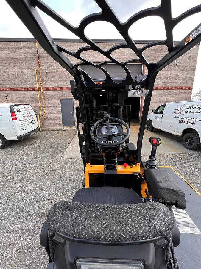 Operator compartment of 2017 Drexel SL-40AC electric SwingMast forklift showing steering wheel, instrument cluster, and CSA safety decals during Brampton deployment