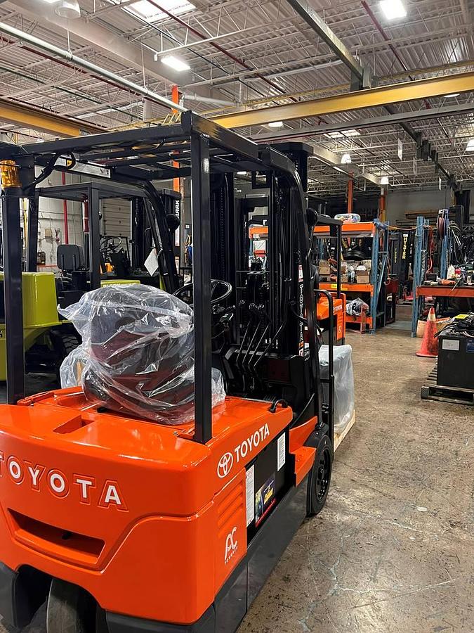 Rear-right angle view of 2013 Toyota 7FBEU20 three-wheel electric forklift showing counterweight, rear cushion tires, battery compartment, and CSA-certified chassis – unit staged in Brampton ON