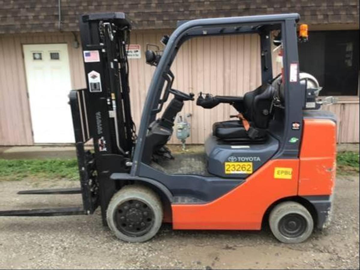 side view of refurbished 2018 Toyota 8FGCU30 LPG cushion forklift showing 171" triple mast, mini-lever hydraulic controls, side shift carriage, and CSA decal during Brampton deployment