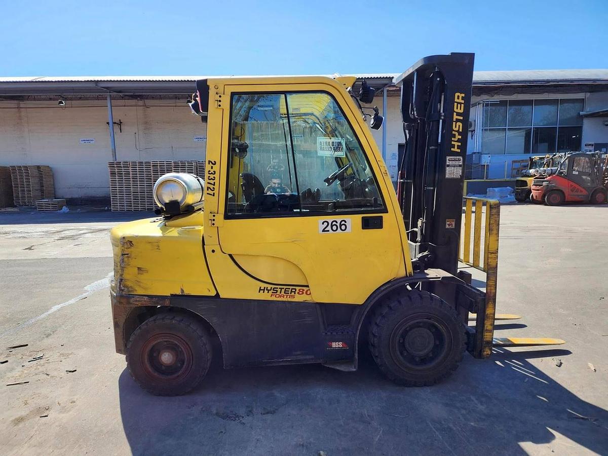 Opposite side view of refurbished 2017 Hyster H80FT LP Gas forklift showing counterweight, cab enclosure, and CSA certification decal during Ontario deployment.