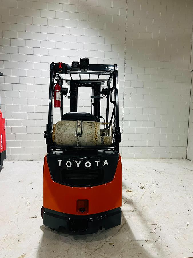 Back view of 2020 Toyota 8FGCU18 propane forklift – CSA-certified 3,500 lb chassis showing rear counterweight, propane tank mount, and safety decals applied, Brampton ON – Premier Lift Equipment