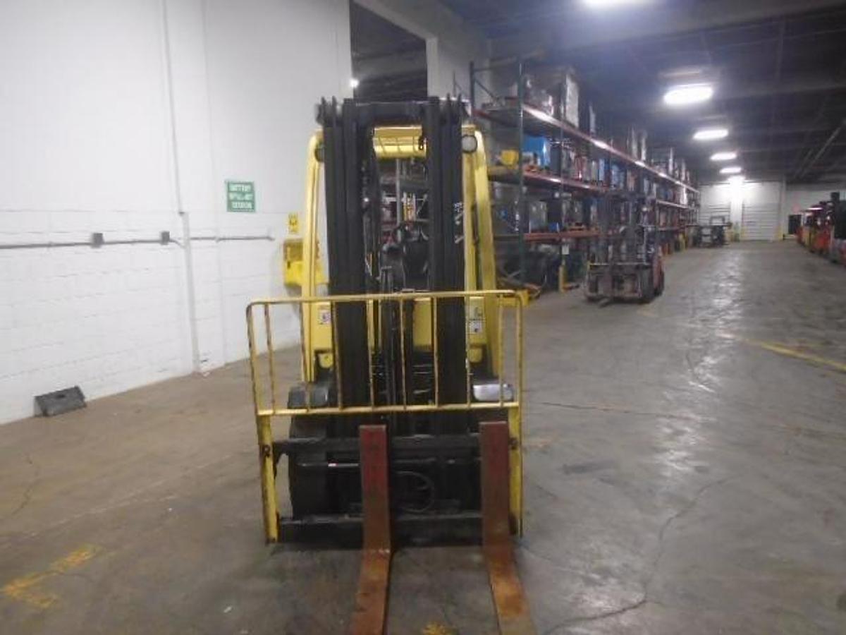 Head-on view of refurbished 2006 Hyster H70FT diesel forklift showing 3-stage mast, forks, pneumatic tires, and operator cab during Brampton deployment