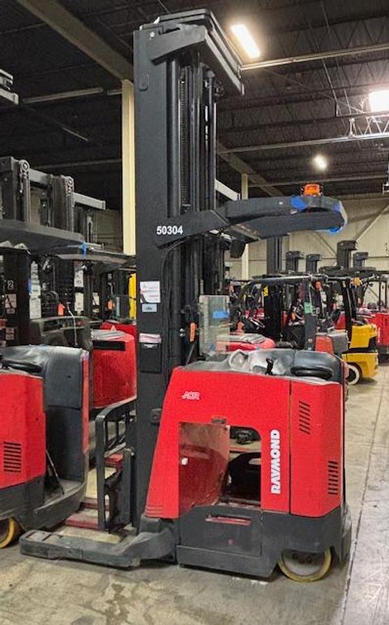 Side view of Raymond 750-DR32TT electric deep reach forklift with pantograph arm and battery installed – CSA-certified 3,200 lb chassis featuring 321” triple mast, side shift, and 36V AC power staged in Brampton ON – Premier Lift Equipment