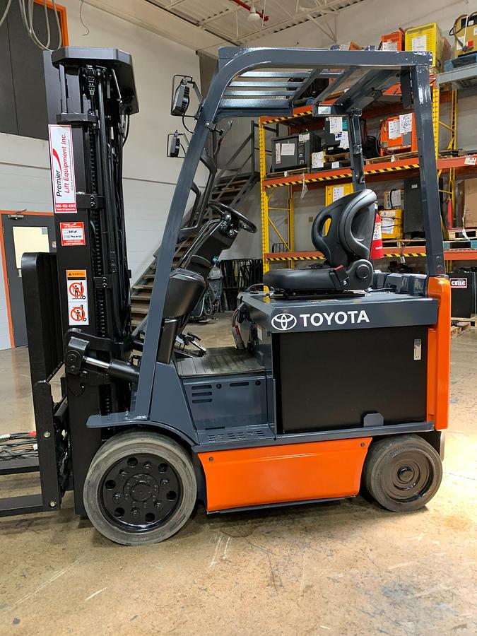 Opposite side view of 2017 Toyota 8FBCU25 electric forklift showing mast rails, CSA decals, and chassis profile during Brampton deployment