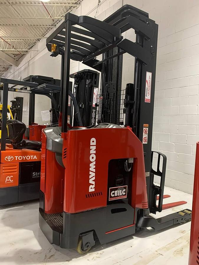 Rear side angle of Raymond 750DR32TT deep-reach forklift showing counterweight, rear wheels, and CSA certification during warehouse deployment