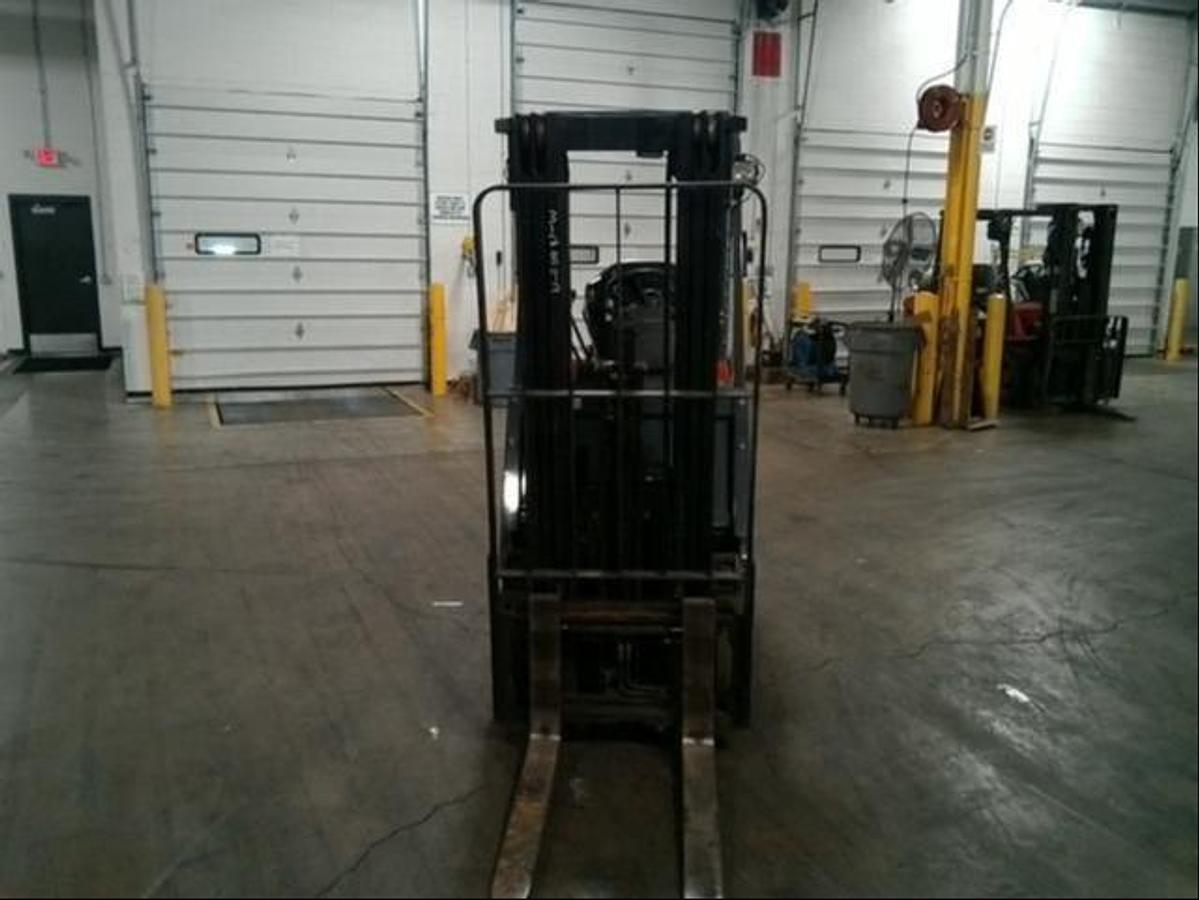 Front view of refurbished 2013 Toyota 7FBCU15 electric 4-wheel sit-down forklift showing fork carriage, mast rails, and side shift mechanism during Ontario deployment