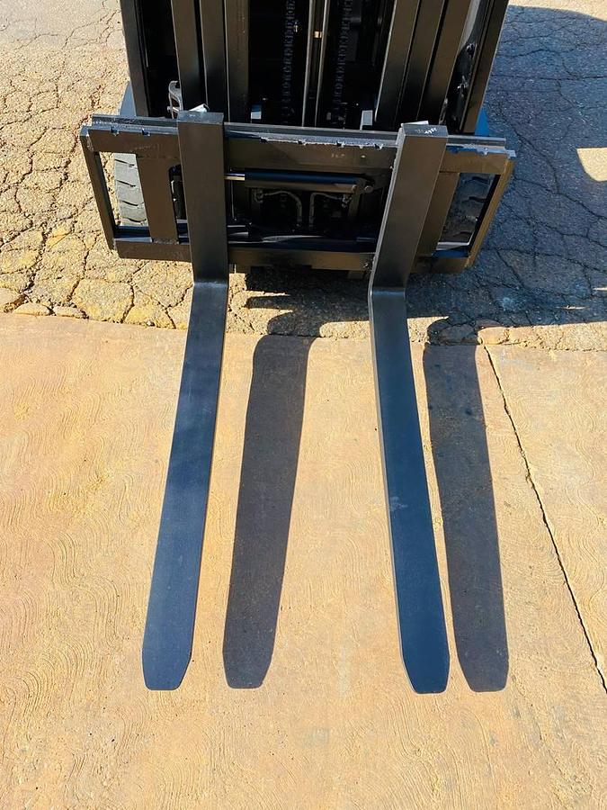 View of refurbished 2018 EP Equipment CPD20 3‑wheel electric forklift showing 42" forks with side shift attachment engaged, solid pneumatic tires, 3‑stage mast, and CSA certification decal during Brampton deployment.