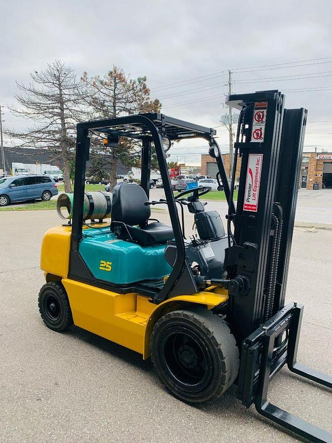 Opposite side view of Komatsu FG25T‑14 forklift showing LP gas tank, pneumatic tires, and CSA compliance markings during Brampton deployment