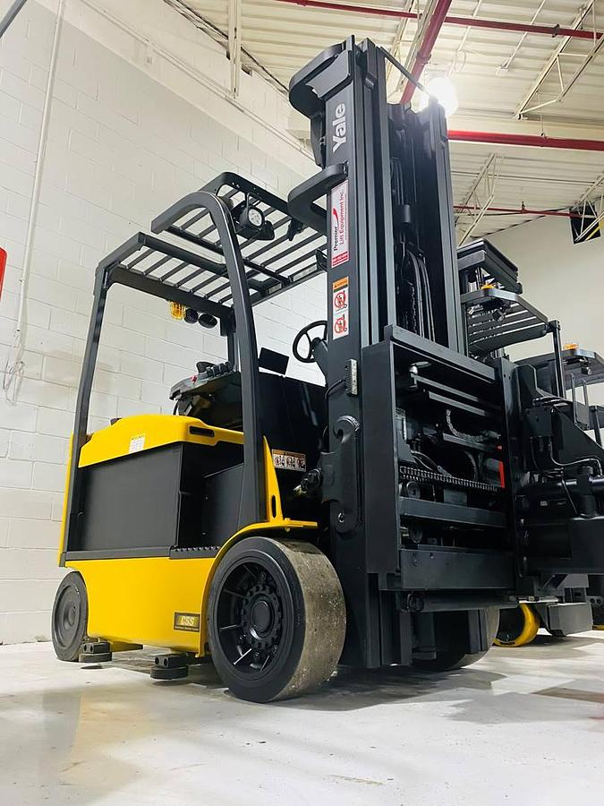 Front angle side view of refurbished 2014 Yale ERC080VHN48TE100 electric cushion tire forklift showing fork tips, mast rails, and CSA certification decal during Ontario deployment