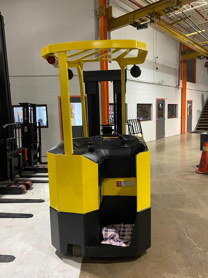Rear view of operator compartment on Hyster E30FR-24 electric dockstocker showing stand-up rider platform, deadman pedal, ergonomic controls, and CSA-certified chassis – unit staged in Brampton ON