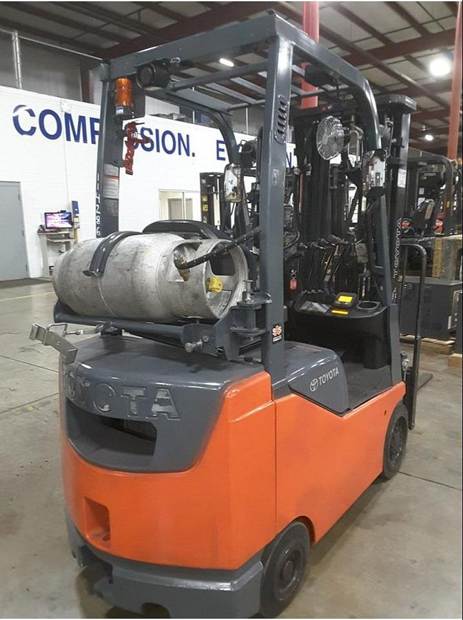 Rear view of refurbished 2014 Toyota 8FGCU18 LP gas forklift showing counterweight, propane tank mount, and CSA inspection tag during Brampton deployment