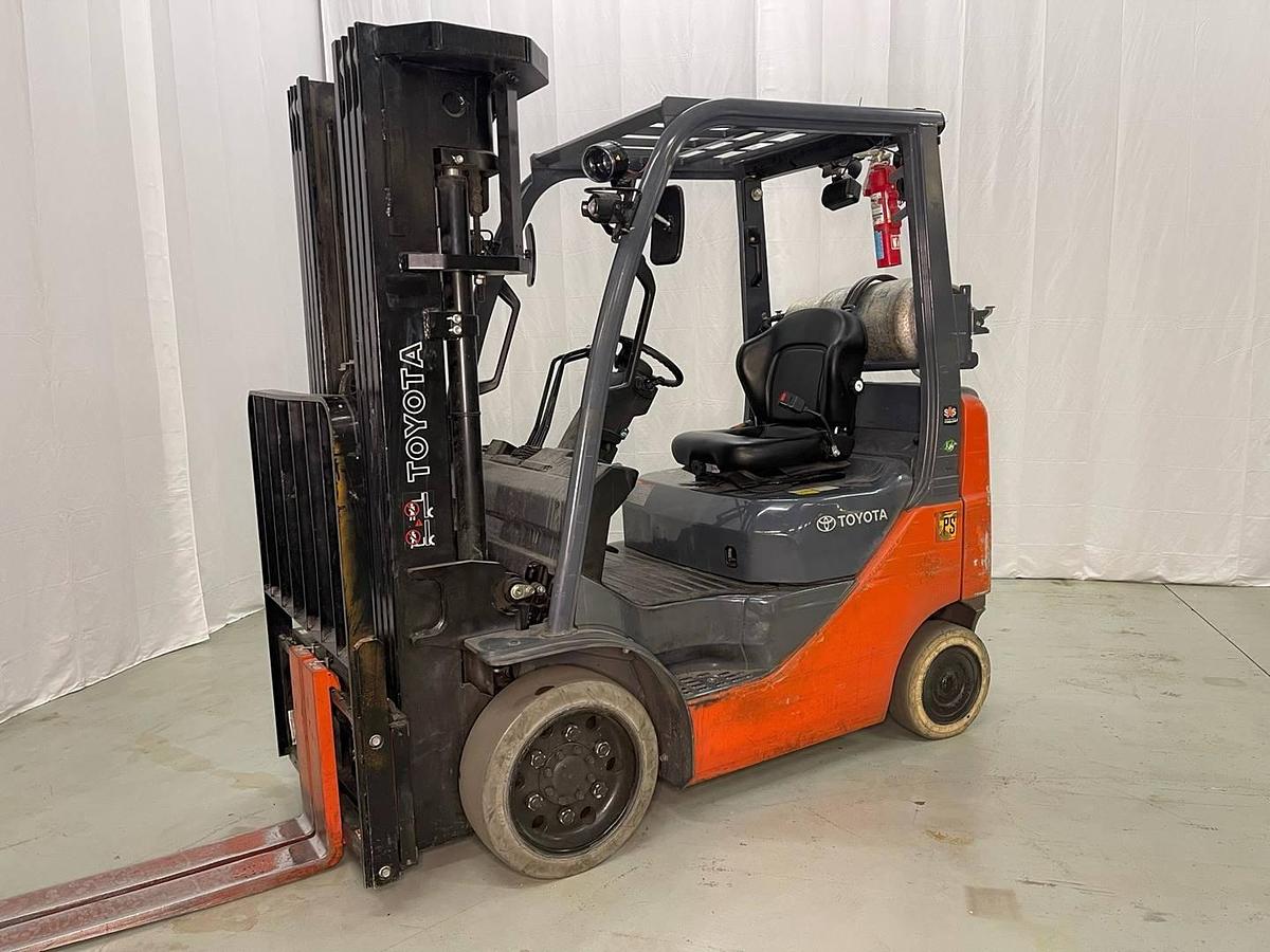 Front side view of refurbished 2015 Toyota 8FGCU20 LP gas forklift showing quad mast, 42" forks, and solid non-marking tires during Brampton deployment