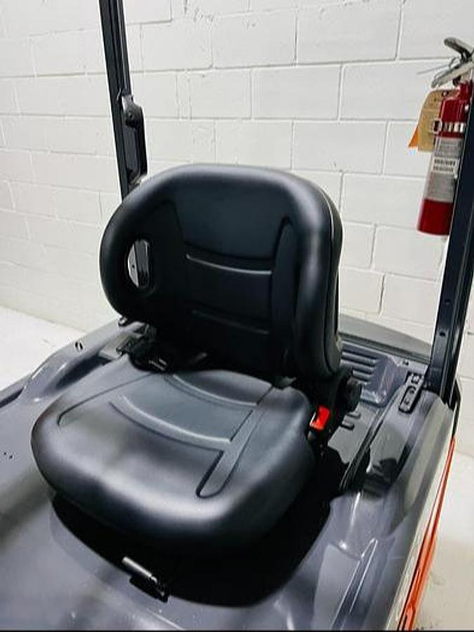 Operator seat of refurbished 2023 Toyota 8FBE20U electric forklift showing safety belt, comfort padding, and SAS sensor during Mississauga deployment
