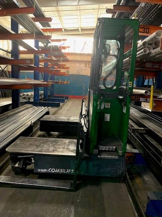 Side view of refurbished 2013 Combilift C6000EST electric multi‑directional forklift showing 48" forks, 48" platform, 216" mast, solid pneumatic tires, and CSA certification decal during Ontario deployment.