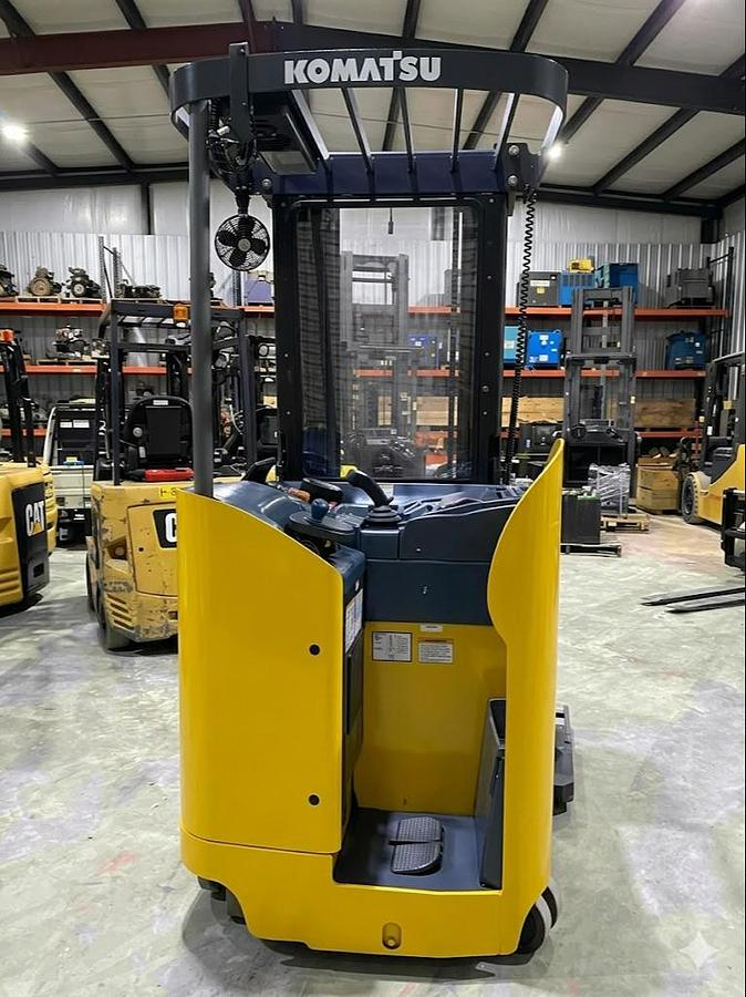 Rear view of Komatsu FR15K‑3 double reach truck showing stand‑up operator compartment and chassis design.