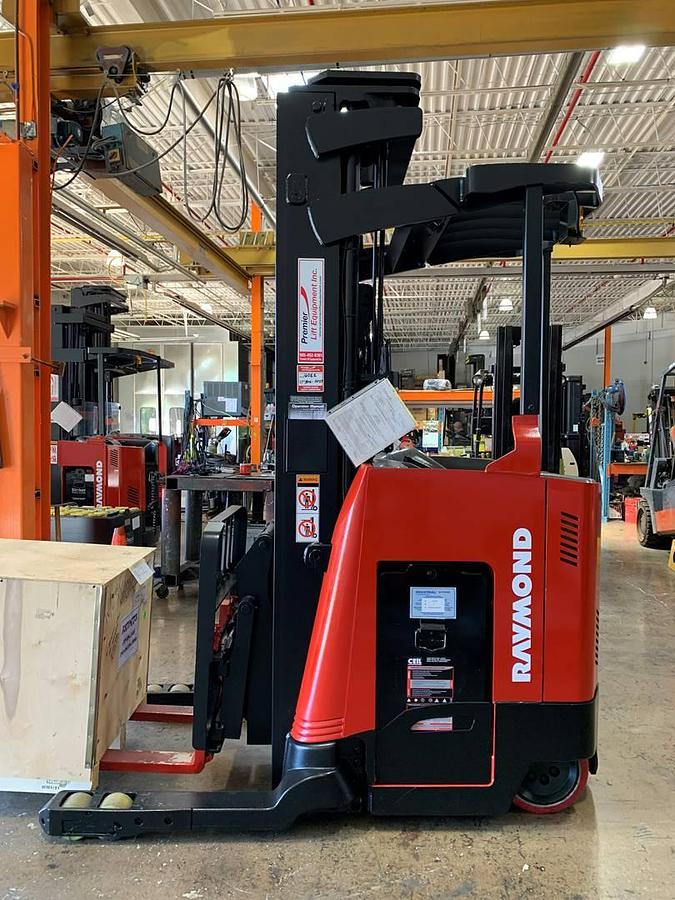 Side profile of Raymond 750DR32TT electric deep-reach forklift showing extended mast rails, reach mechanism, and chassis layout during Brampton deployment