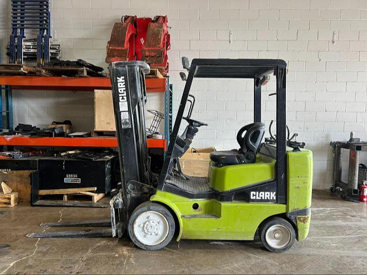 Budget Clark CGC25 LPG cushion forklift, older non‑CSA unit for light‑duty indoor/outdoor shop work.