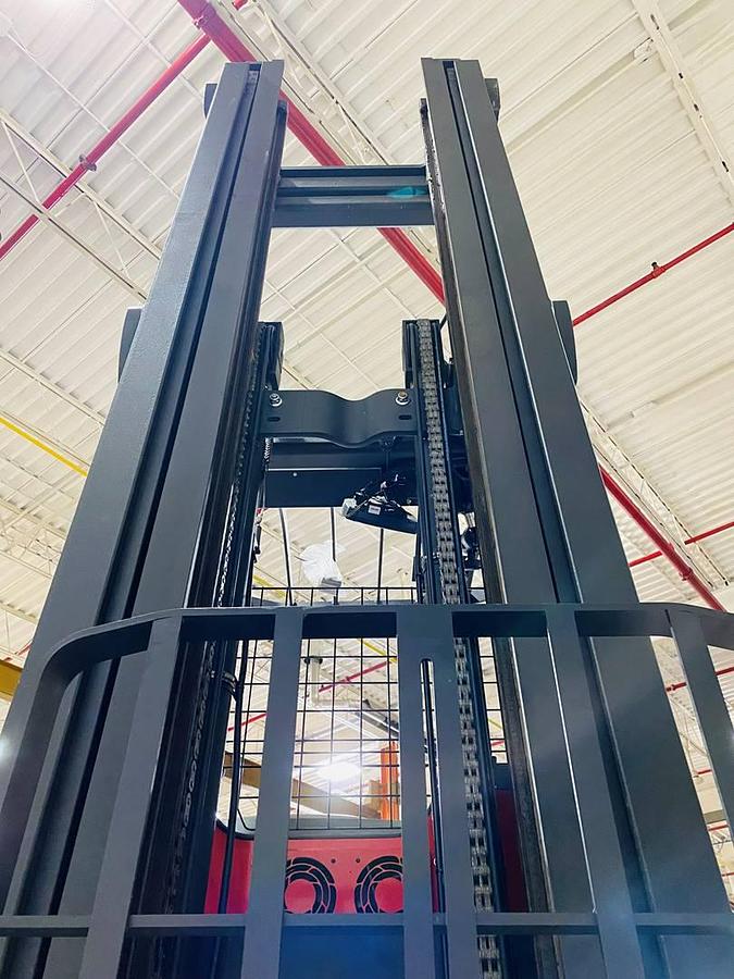 Close-up rear view of Raymond 752 DR32TT deep-reach forklift showing triple mast channels, welded load backrest, and CSA safety decals during Brampton deployment