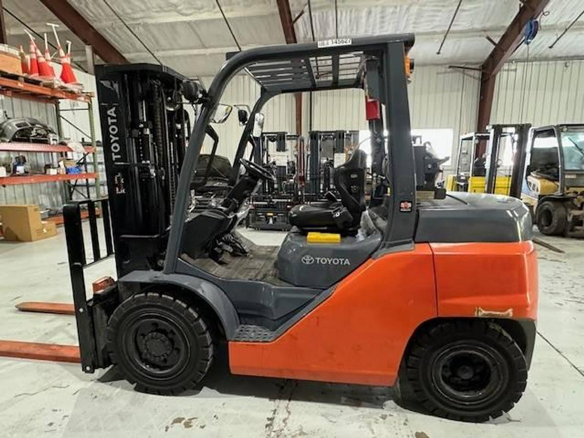 Opposite side view of refurbished Toyota LP gas forklift showing rear chassis, propane tank mount, and CSA decal during Brampton deployment