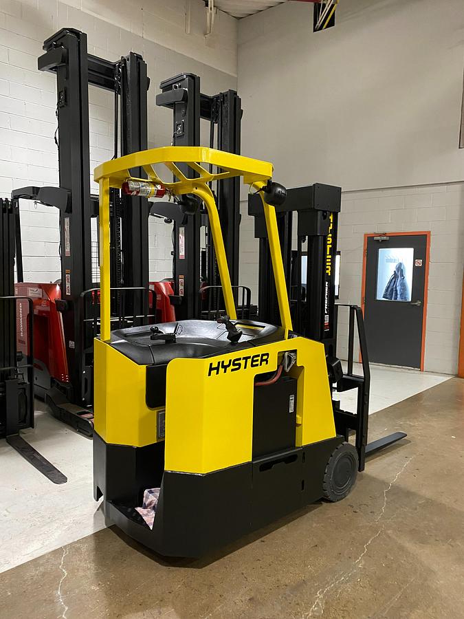 Rear-right angle view of Hyster E30FR-24 electric dockstocker showing stand-up rider platform, rear-wheel drive configuration, and CSA-certified chassis – unit staged in Brampton ON