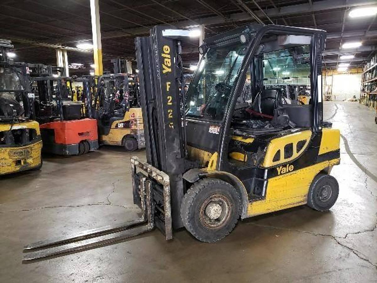 Front side angle of Yale GLP050VX LPG pneumatic forklift showing full cab enclosure, fork positioner, and outdoor-ready tires during Brampton deployment