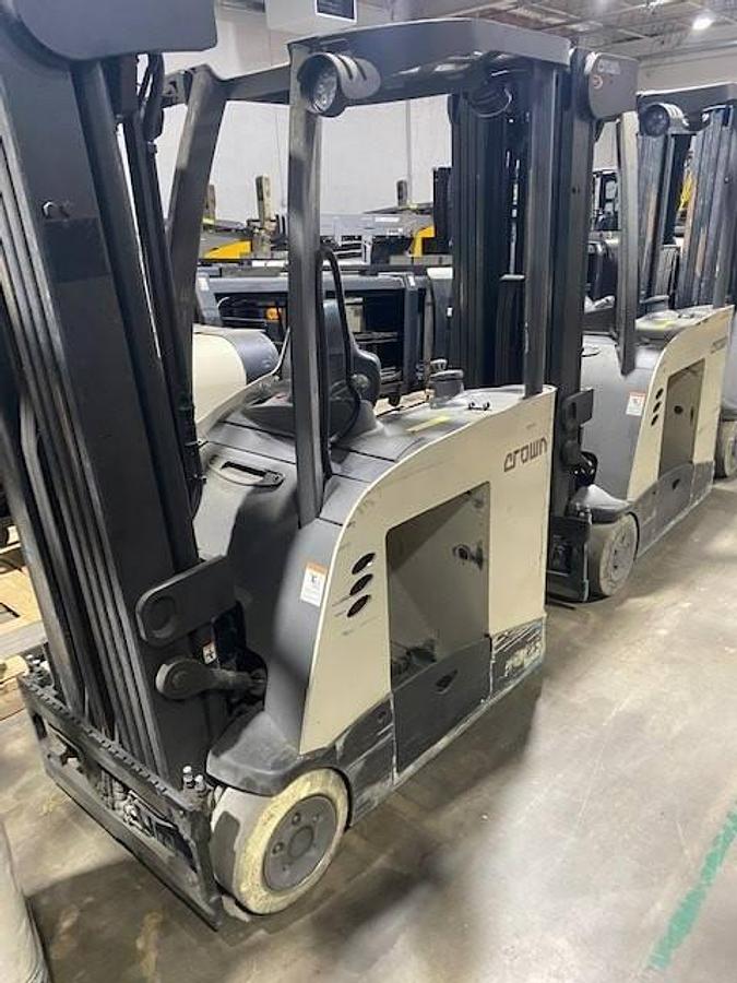 Side view of refurbished 2017 Crown RC5545‑40 electric forklift showing 42" forks, 260" quad mast, side shift, and CSA certification decal during Ontario deployment.