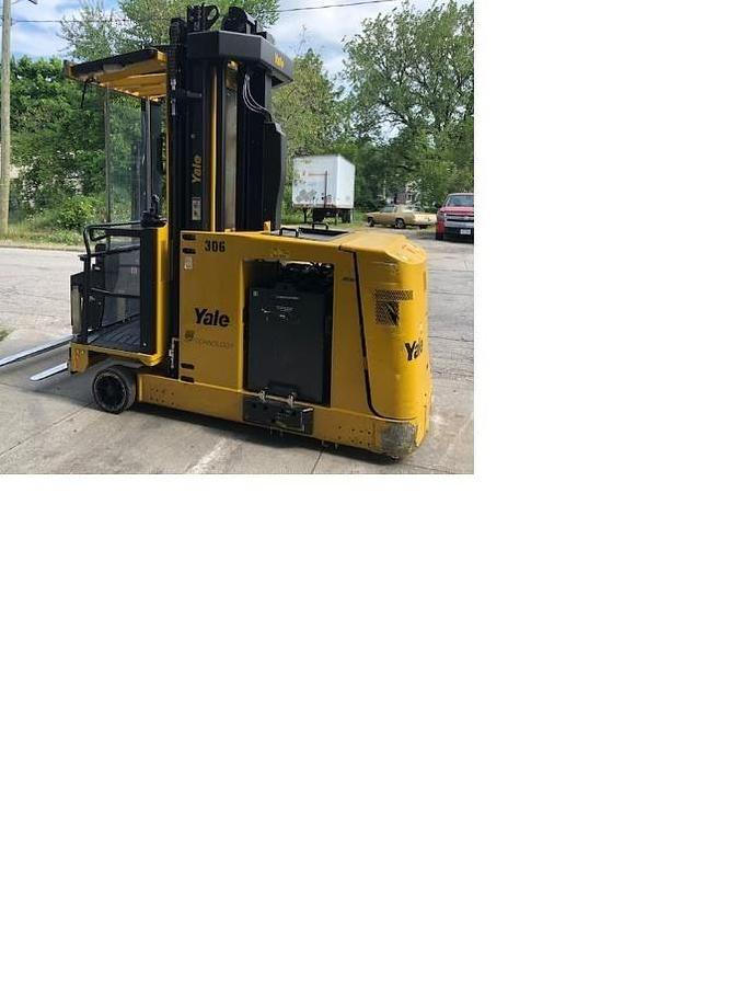Opposite side view of refurbished 2013 Yale NTA030SB electric man‑up swing reach turret truck showing battery compartment, mast rails, and CSA certification decal during Ontario deployment.