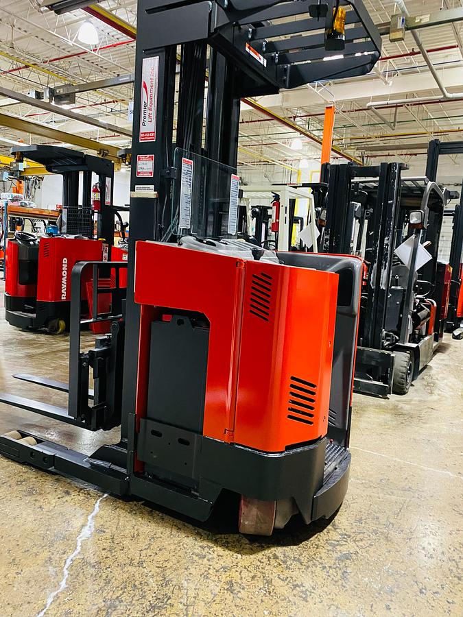 Rear view of refurbished 2013 Raymond EASIR30TT reach truck showing reach mast, battery compartment, and CSA decals during Mississauga deployment