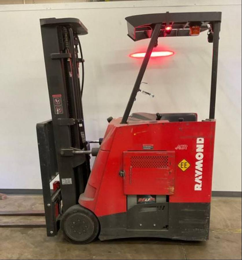 Side view of refurbished 2013 Raymond 425-C30TT EE-rated electric dockstocker showing battery compartment, chassis frame, and reach carriage during Mississauga deployment