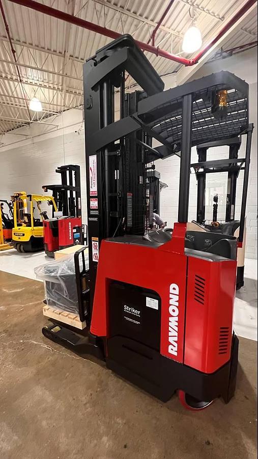 Side view of CSA-certified Raymond 750-R45TT reach truck with triple mast and poly tires – staged in Brampton ON