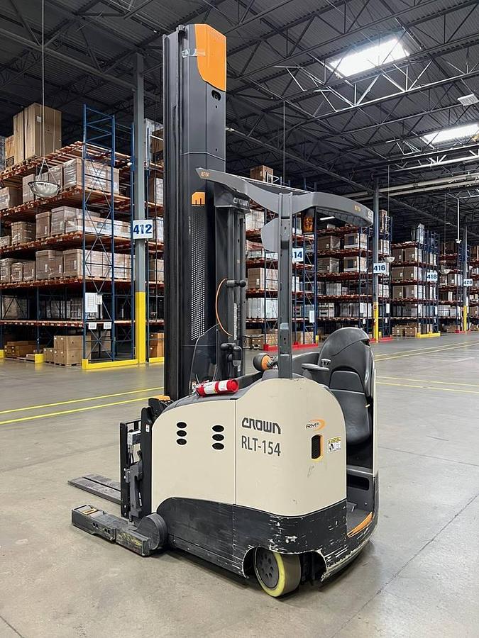 Rear side view of refurbished 2021 Crown RM6095S electric reach truck showing rear chassis, 36 volt battery compartment, and CSA certification decal during Ontario deployment.