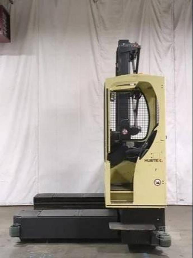 Opposite side view of Hubtex MQ45 electric multidirectional sideloader showing operator cab, steering system, and CSA-certified chassis – unit staged in Brampton ON