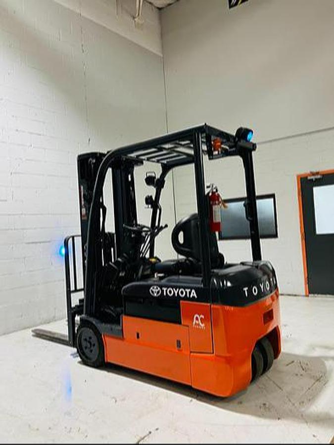 Opposite rear side angle of refurbished 2023 Toyota 8FBE20U electric forklift showing rear caster wheel, chassis layout, and freezer-compatible configuration during Mississauga deployment