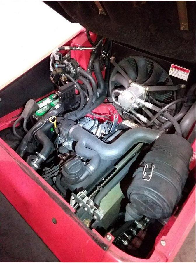 Engine compartment of refurbished 2016 Linde H25CT LPG forklift showing LP gas powertrain, ignition system, cooling assembly, solid tire chassis, and CSA/MOL certification decal during Brampton deployment.