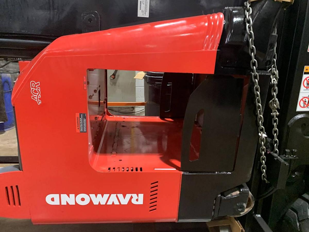 Close-up view of refurbished 2019 Raymond 772-R45TT electric reach truck showing 21" battery box, compartment door, and cable routing during Toronto deployment