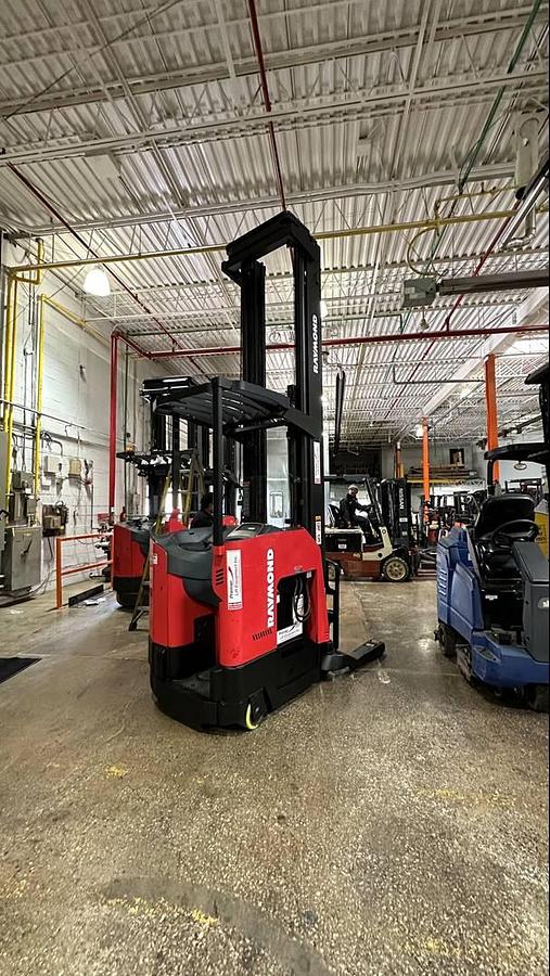 Side view of 2016 Raymond 750‑DR32TT electric double‑deep reach truck showing pantograph reach mechanism and narrow‑aisle chassis