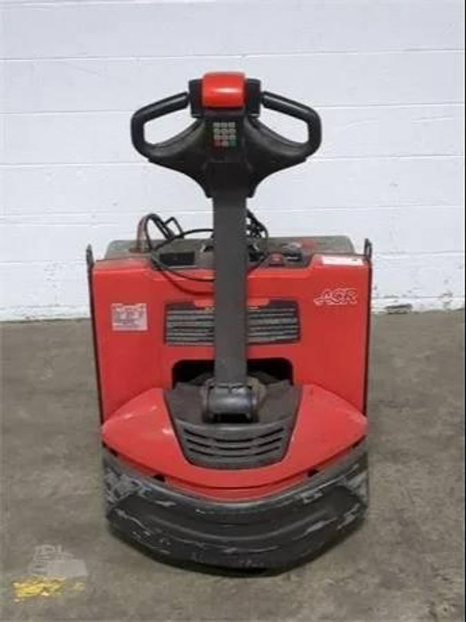 Rear view of refurbished 2018 Raymond 8250 electric walkie pallet truck showing tiller arm, control head, and charger port during Oakville deployment