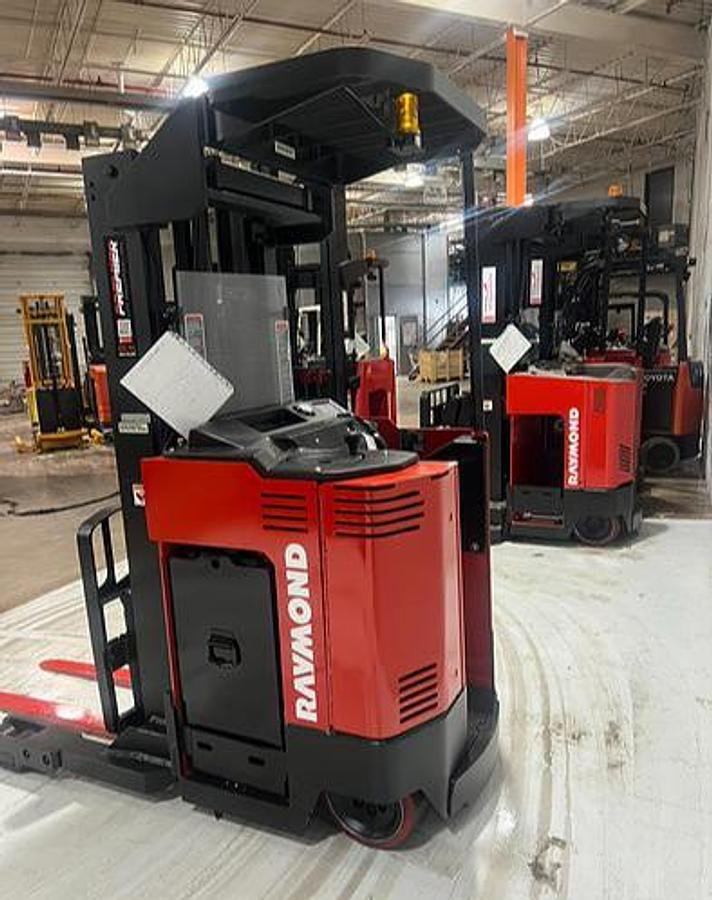 Side profile of Budget Raymond 31I‑R45TT stand‑up reach truck — narrow chassis and 180” mast.