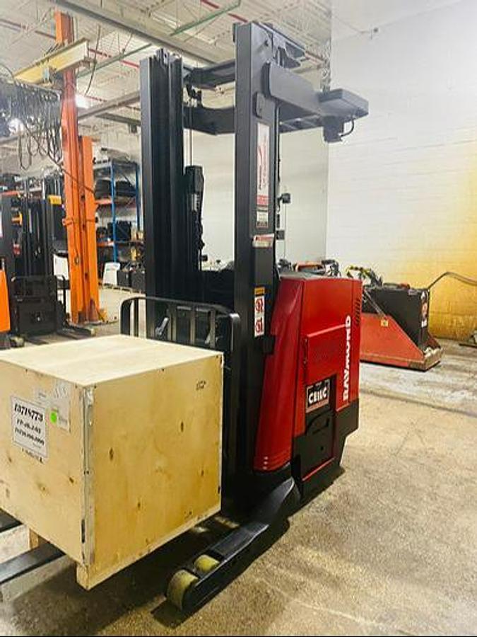 Front view of refurbished 2014 Raymond 750-R45TT EE-rated reach truck showing fork carriage, mast rails, and side shift mechanism during Ontario deployment