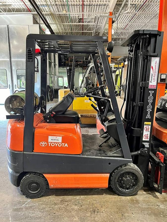 side view of refurbished 2000 Toyota 42-6FGCU15 LP gas forklift showing operator cab, rear chassis, and CSA decal during Brampton deployment