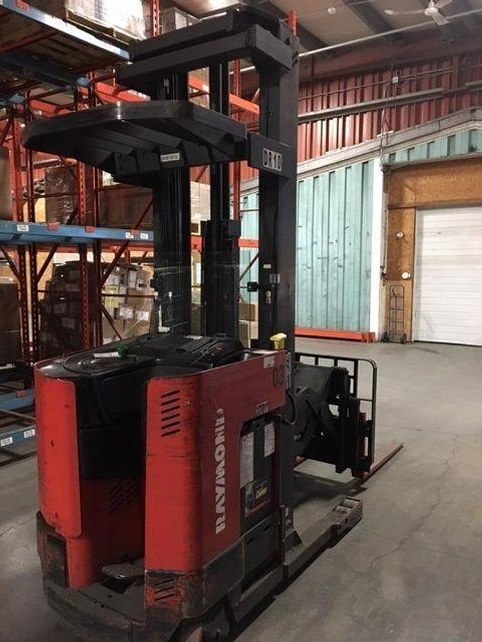 Rear angle side view of refurbished 2007 Raymond EASIDR25TT electric double reach forklift showing operator compartment, counterweight, and rear chassis during Ontario deploymen