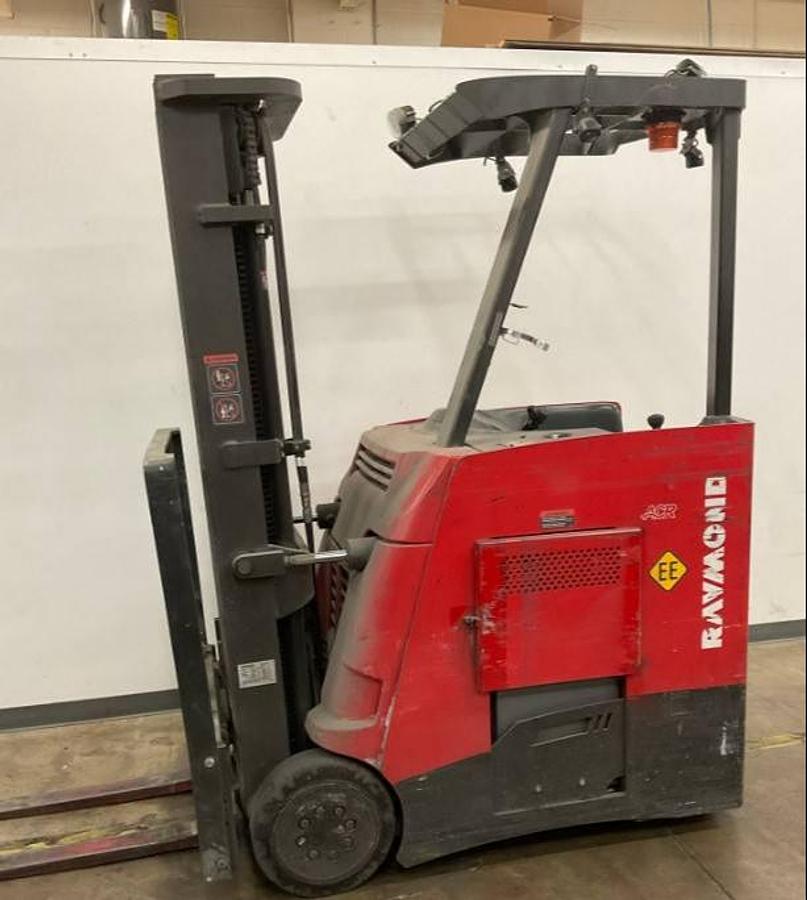 Side view of refurbished 2013 Raymond 425-C30TT EE-rated electric dockstocker showing battery compartment, chassis frame, and reach carriage during Vaughan deployment